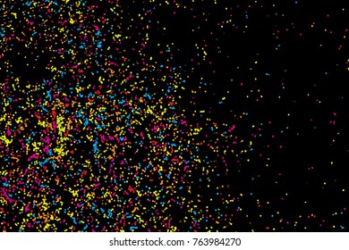 Black background with many falling tiny round random confetti, glitter and serpentine pieces blow and sprayed on black background. Isolated.