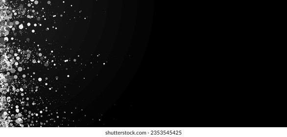 Black background with silver glitter. Silver particles sparkle.