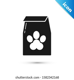 Black Bag of food for pet icon isolated on white background. Food for animals. Pet food package. Dog or cat paw print.  Vector Illustration