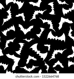 Black bats swarm isolated on vector Halloween background. Silhouettes of flying bats. Seamless pattern with bats. Wallpaper, print, packaging, paper, textile design. Vector illustration.
