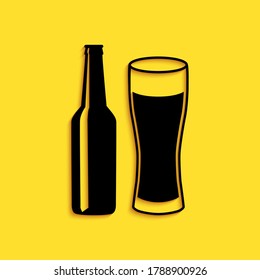 Black Beer bottle and glass icon isolated on yellow background. Alcohol Drink symbol. Long shadow style. Vector.