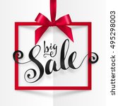 Black Big Sale vector calligraphic sign in red frame hanging on silky ribbon with bow. Ink calligraphy Big Sale sign. Red square frame with silky bow. Hand drawn lettering on folded paper background.