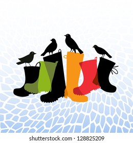 black birds resting on rubber rainboots