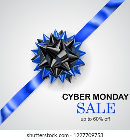 Black and blue bow with diagonally ribbon with shadow and inscription Cyber Monday Sale on white background
