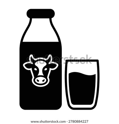 A black bottle of milk with a cow logo sits next to a glass of milk on a white background