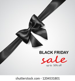 Black bow with diagonally ribbon with shadow and inscription Black Friday Sale on gray background