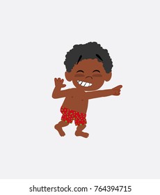 Black boy in a swimsuit pointing to something funny on his left.
