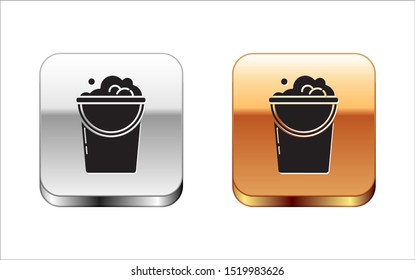 Black Bucket with foam and bubbles icon isolated on white background. Cleaning service concept. Silver-gold square button. Vector Illustration
