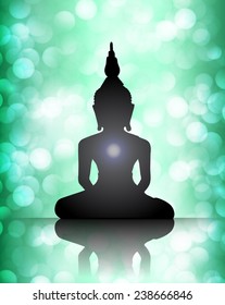 Black Buddha silhouette against blue bokeh defocused lights abstract background 