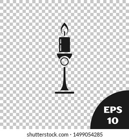 Black Burning candle in candlestick icon isolated on transparent background. Old fashioned lit candle. Cylindrical candle stick with burning flame.  Vector Illustration