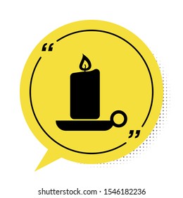 Black Burning candle in candlestick icon isolated on white background. Old fashioned lit candle. Cylindrical candle stick with burning flame. Yellow speech bubble symbol. Vector Illustration