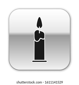 Black Burning candle in candlestick icon isolated on white background. Cylindrical candle stick with burning flame. Silver square button. Vector Illustration