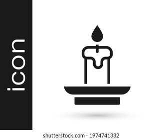 Black Burning candle icon isolated on white background. Cylindrical aromatic candle stick with burning flame. Happy Halloween party.  Vector