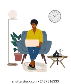 Black business woman working at laptop at home.