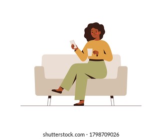 The black businesswoman is sitting on the couch with a mobile phone at the break time. Young dark skin girl drinking coffee and using a smartphone. Flat cartoon vector illustration.