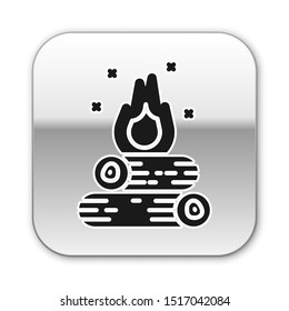 Black Campfire icon isolated on white background. Burning bonfire with wood. Silver square button. Vector Illustration