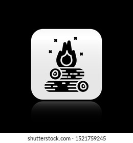 Black Campfire icon isolated on black background. Burning bonfire with wood. Silver square button. Vector Illustration