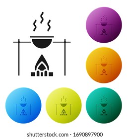 Black Campfire and pot icon isolated on white background. Fire camping cooking in cauldron on firewood and flame. Set icons in color circle buttons. Vector Illustration