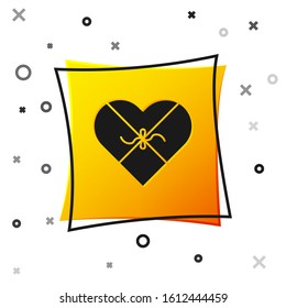 Black Candy in heart shaped box and bow icon isolated on white background. Valentines Day. Yellow square button. Vector Illustration