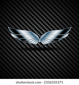 Black carbon background with chrome metal wings silhouette emblem