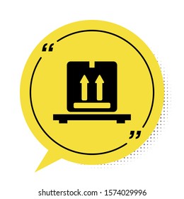 Black Cardboard boxes on pallet icon isolated on white background. Closed carton delivery packaging box with fragile signs. Yellow speech bubble symbol. Vector Illustration