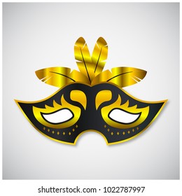 black carnival mask having golden design elements and stroke and feathers on grey background