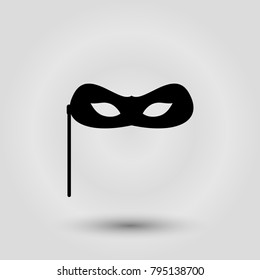 Black carnival mask for masquerade costume. Isolated on grey background