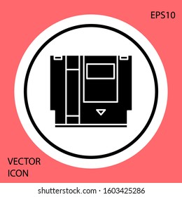 Black Cartridge for retro game console icon isolated on red background. TV Game cartridge. White circle button. Vector Illustration
