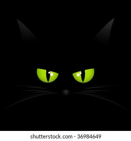 Black cat with intense green eyes staring out from a black background