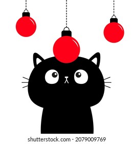 Black cat kitten face looks at red Merry Christmas ball. Cute cartoon kawaii funny pet baby character. Xmas Greeting card print. Flat design. Isolated. White background. Vector illustration