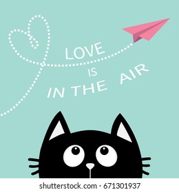 Black cat looking up to pink flying origami paper plane. Dashed line Heart loop Love is in the air text. Cute cartoon animal character. Valentines Day. Greeting card Flat design Blue background Vector