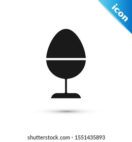 Black Chicken egg on a stand icon isolated on white background.  Vector Illustration