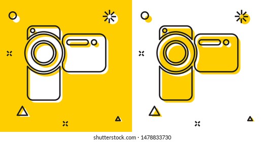 Black Cinema camera icon isolated on yellow and white background. Video camera. Movie sign. Film projector. Random dynamic shapes. Vector Illustration