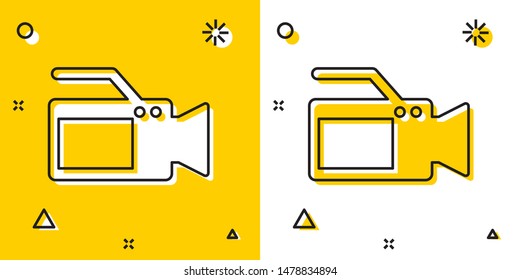 Black Cinema camera icon isolated on yellow and white background. Video camera. Movie sign. Film projector. Random dynamic shapes. Vector Illustration