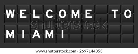 Black color analog flip board with word welcome to miami on gray background