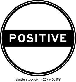 Black color round seal sticker in word positive on white background