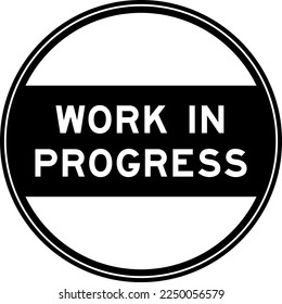Black color round seal sticker in word work in progress on white background