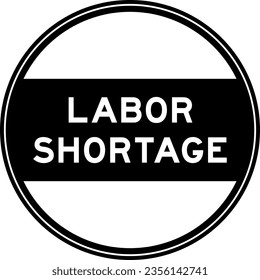 Black color round seal sticker in word labor shortage on white background