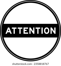 Black color round seal sticker in word attention on white background
