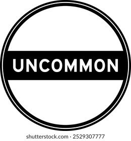 Black color round seal sticker in word uncommon on white background