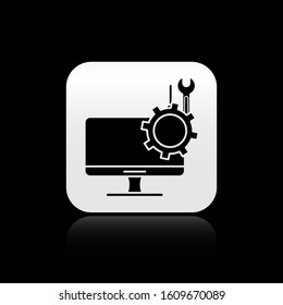 Black Computer monitor with screwdriver and wrench icon isolated on black background. Adjusting, service, setting, maintenance, repair. Silver square button. Vector Illustration