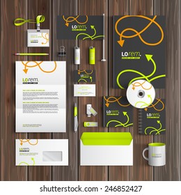 Black corporate identity template design with green and orange arrows. Business stationery