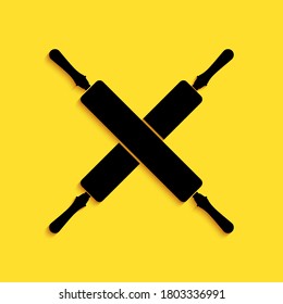 Black Crossed rolling pins icon isolated on yellow background. Kitchen utensils and equipment. Long shadow style. Vector.