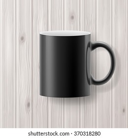 Black cup or mug isolated on wooden backdrop