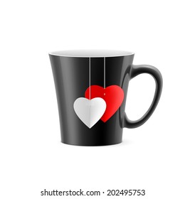 Black cup with tapered bottom with a tea bag in the form of hearts
