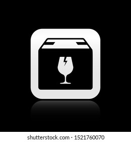 Black Delivery package box with fragile content symbol of broken glass icon isolated on black background. Box, package, parcel sign. Silver square button. Vector Illustration