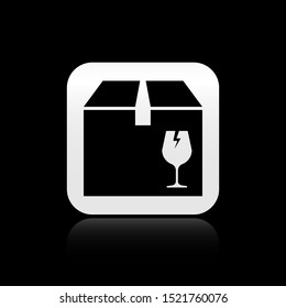 Black Delivery package box with fragile content symbol of broken glass icon isolated on black background. Box, package, parcel sign. Silver square button. Vector Illustration