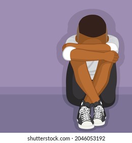 Black depressed boy sitting on floor alone bullying or depression concept 
