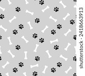 Black domestic pet's paws prints and white bones on gray background. Vector seamless pattern.