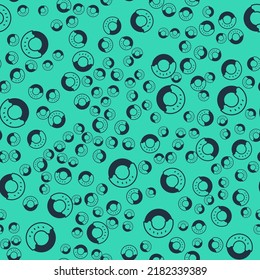 Black Donut with sweet glaze icon isolated seamless pattern on green background.  Vector